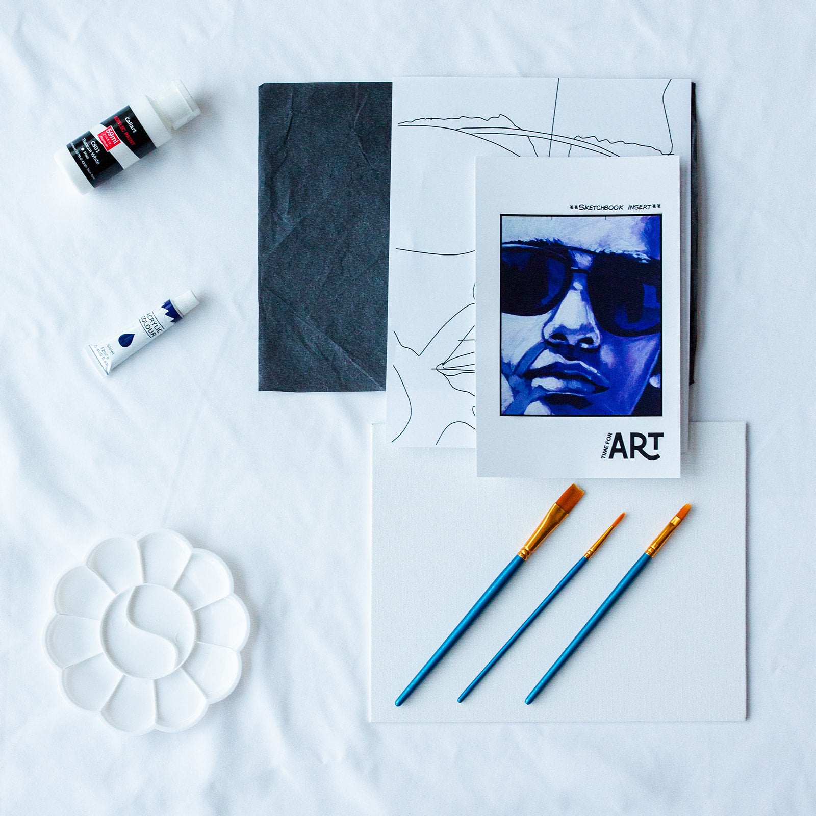 A picture of what is included in the Time For Art Purple Sunglasses Painting Kit. The DIY Kit comes with 2 paints, a palette, the outline, brushes, canvas and more! 