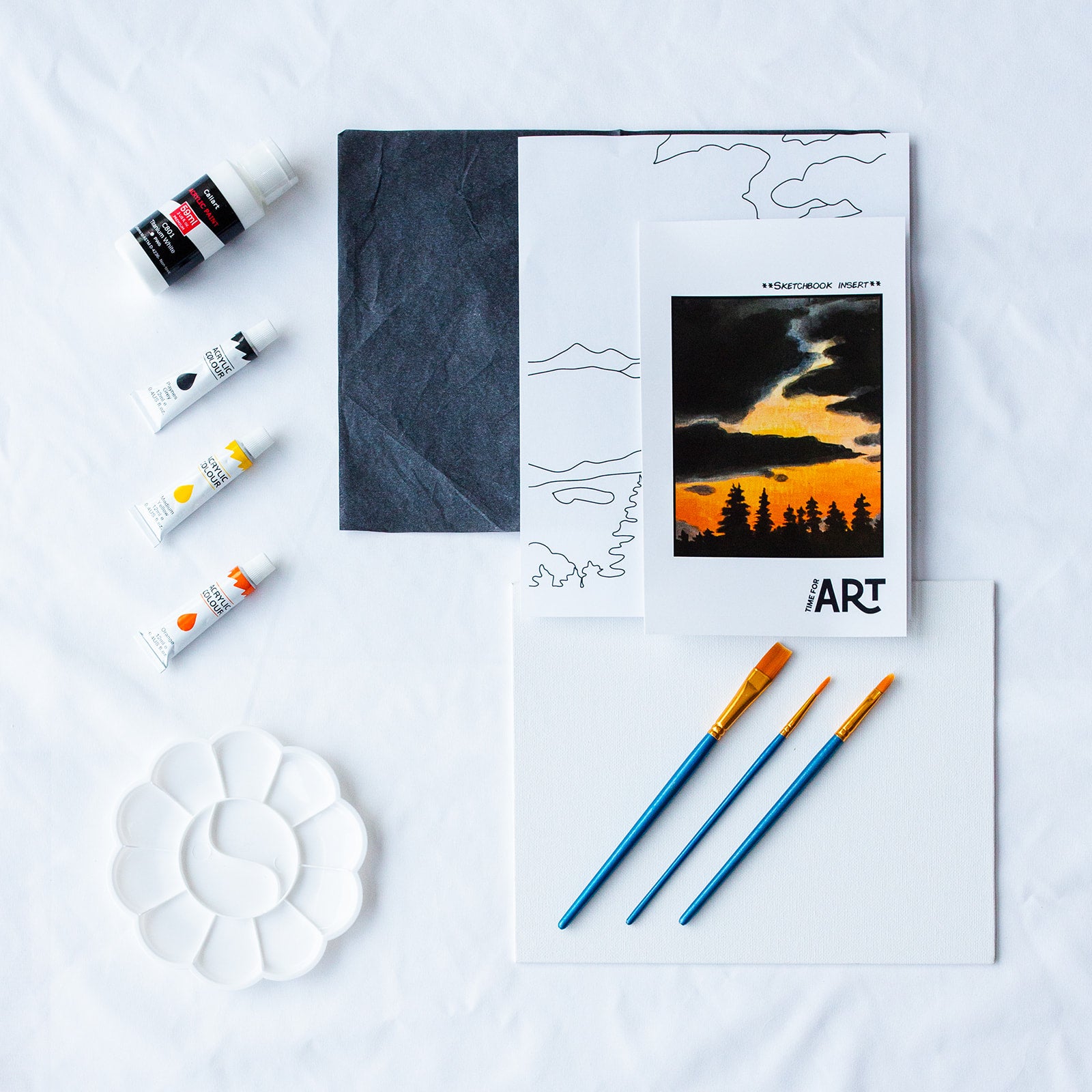 A picture of what is included in the Time For Art Coastal Redwood Sunset Painting Kit. The DIY Kit comes with 4 paints, a palette, the outline, brushes, canvas and more! 